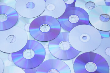 Lots of old CDs are laid out as a background.