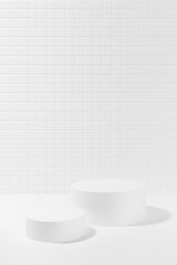 White abstract stage mockup with two cylinder podiums in hard light, shadow, template for presentation cosmetic products, spa, goods, advertising, showcase, tiny mosaic tile in elegant simple style.