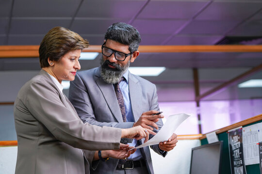 Indian businessman discussing to his secretary at office