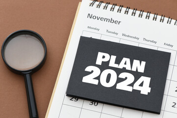 Business concept of planning 2024. PLAN 2024 words on a black sheet placed on a calendar.