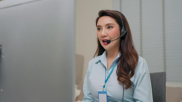 Asian businesswoman wearing headset working in office to support remote customer. Call center and customer service support concept