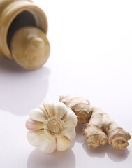 raw ginger and garlic with glass jar