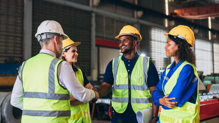 Team engineers and foreman stack hand and shake hands to show success at factory machines. Worker industry join hand for collaboration.
