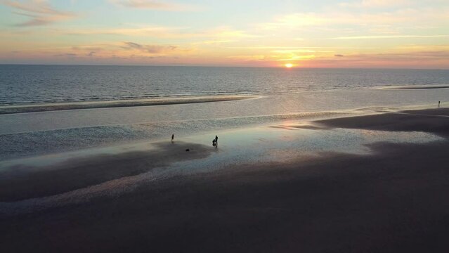 Drone shot beautiful sunset and sand beach on coast of Romo Island
