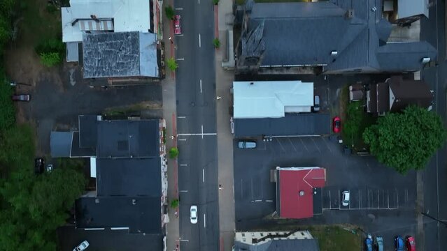 Overhead view of downtown Milton, Pennsylvania with a car moving along with drone video looking down, moving forward.