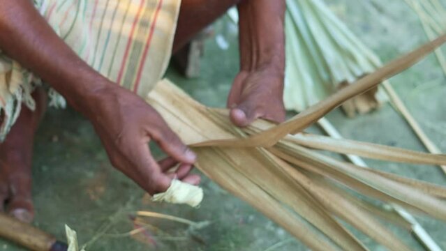 Hands weaving bamboo basket, handmade by Villagers in rural india 