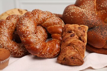 Different tasty freshly baked pastries on table, closeup
