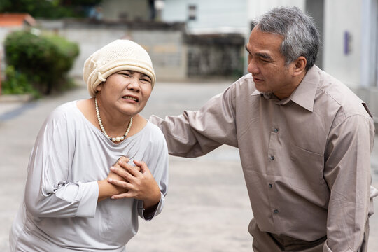 Old Senior Woman Cancer Patient Wearing Chemotherapy Hair Loss Covering Hat, Feel The Sickness Pain Relapse Due To Chemotherapy Adverse Event Or Negative Side Effect, Taken Care By Family Member