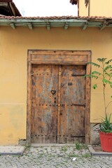 Wooden door of a traditional Konya house in Aziziye District. Metal doorknob. Konya, Turkey.