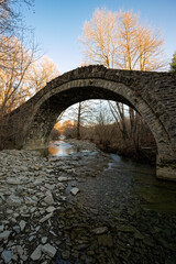 View of the traditional stone Riziana Bridge in Zagori of Epirus, Greece.