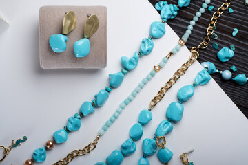 author collection jewelry with azure gemstones, pearls and chain demonstrated at white  background....