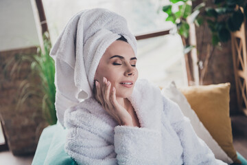 Photo of attractive woman lying sofa touch face fingers enjoy after bath using daily gel in modern...