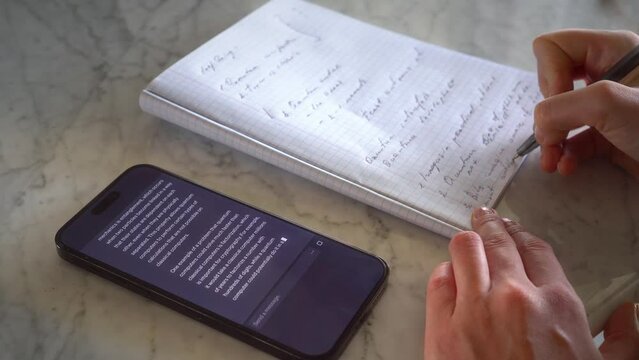 Girl using AI chatbot app on her smartphone to do homework for school assignment, research. AI revolution in Education, sourcing information from artificial intelligence, generative text in real time