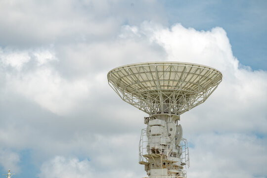 isolated earth terminal  satellite communication receiver with cloudy sky.