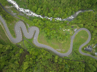Twisting mountain road top down aerial view.