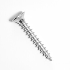 Closeup of metal screw with shadow on white background.