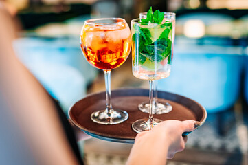 glasses alcohol cocktail set on a waiter tray in bar