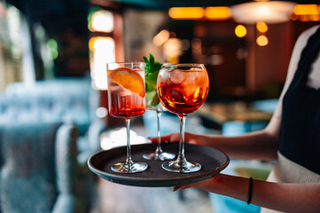 glasses alcohol cocktail set on a waiter tray in bar