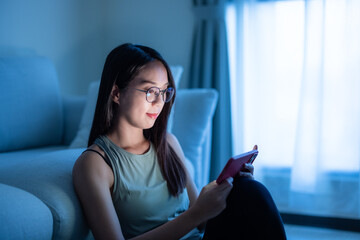 Woman with glasses and use of cellphone at home in the evening