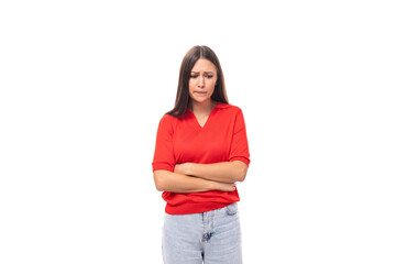 young distressed caucasian brunette in a red short sleeve shirt on a white background with copy space