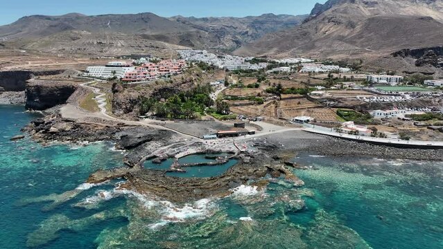 wonderful aerial shot in orbit over the coast of the port of Agaete in which they appreciate the natural pools of the area. On a sunny day. Canary Islands.