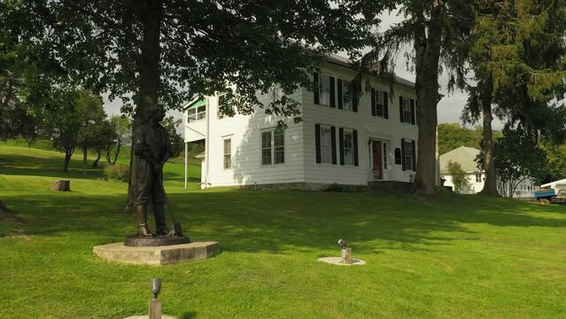 statue at the front of Original Historic House of Josiah Stowell friend of Joseph Smith hired him for money or Treasure digging in the early 1820s where he stayed when he got married. Mormon Origins.