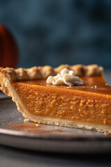 Beautiful close-up of a slice of delicious pumpkin pie indoors, made with generative AI