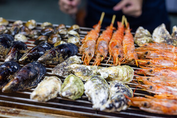 Mixed seafood barbecue on grill metal net