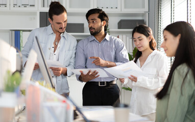 Fototapeta premium Diverse group, teamwork of multiethnic businesspeople meeting startup business project in corporate office. Indian businessman and team talking, brainstorming creative marketing strategy together.