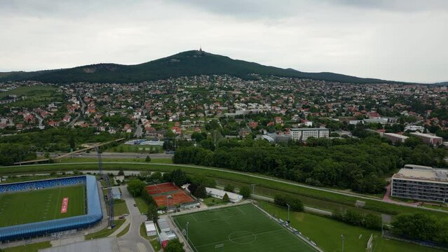 Aerial view of Nitra, football pitch and Zobor Mountain on the horizon, 4k