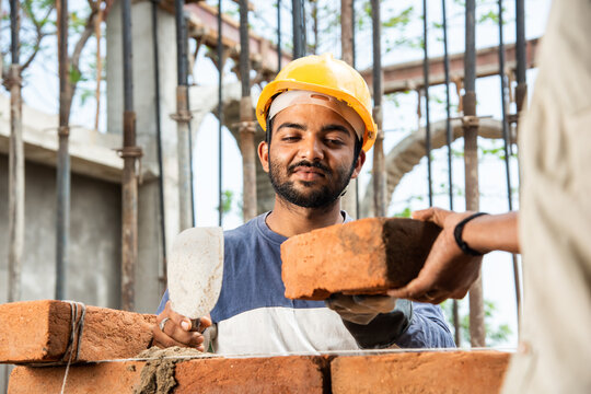 Happy Indian Male Construction Worker Constructing Brick Wall - Hard Working Concept, Manual Labour