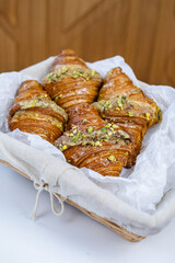 croissants in a wicker basket on a white table