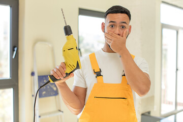 arab handsome man arab man covering mouth with a hand and shocked or surprised expression. handyman...