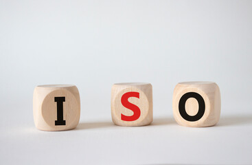 ISO standards quality control symbol. Concept word ISO on wooden cubes. Beautiful white background. Business and ISO concept. Copy space.