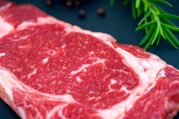 Beef filet mignon steaks, Wagyu fillet steak with rosemary, pepper on dark background.