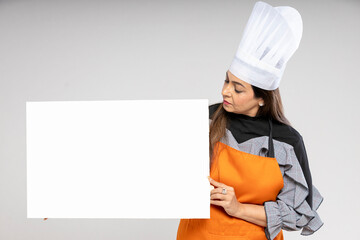 Indian smiling female chefs, cooks or bakers showing blank board on white background.