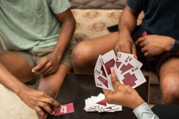black people playing cards at home