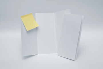 Folded paper with notes attached on white background