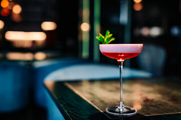alcoholic cocktail in a glass stands on a table in a bar or restaurant