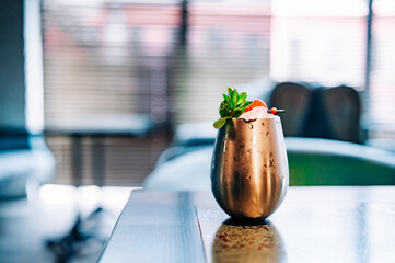 alcoholic cocktail in a glass stands on a table in a bar or restaurant