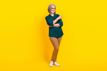 Fototapeta na wymiar Full length photo of positive aged person look direct finger empty space isolated on yellow color background