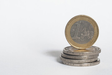 European Union coins stacked on top of each other on a white background. Money in the European Union - Euro