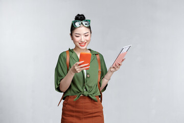 Traveler tourist woman hold passport boarding ticket mobile cell phone isolated on white background