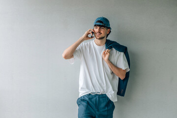 portrait of young male in cap talking on mobile phone