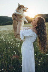 Beautiful woman with a dog in nature