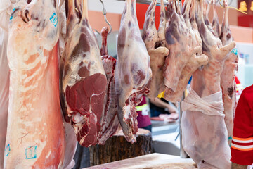 Dubai, Deira waterfront meat market, April 2023: Retailers offer fresh meat at their stalls. Lamb and beef hang on the bar.