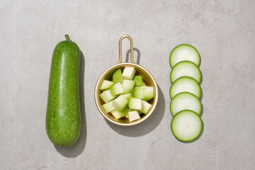 Golden pot containing small winter melon slices. Winter melon (Benincasa hispida) can reduce the...