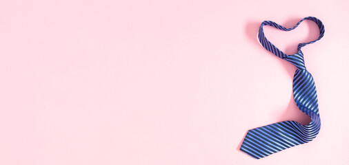 Father's day concept. Flat lay top view of tie on pastel pink background with place for text, promotional and  greeting message, banner