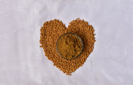 Fenugreek Seeds (Methi Dana) in heart shape on white background. Shambhala or helba seeds is a traditional Indian seasoning Ayurvedic food. Used in culinary and medicine.