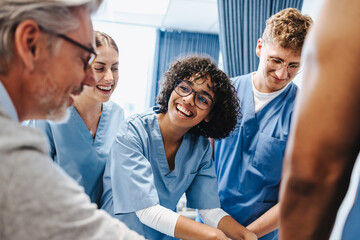 Health students receiving medical training from a senior doctor in a teaching hospital
